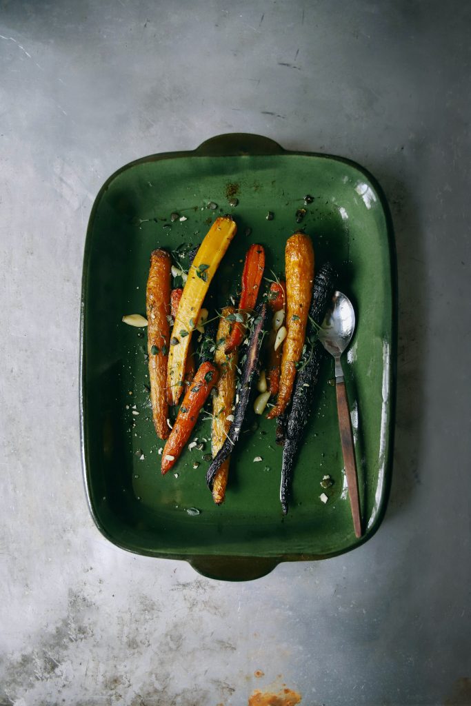 Roasted carrots in green dish